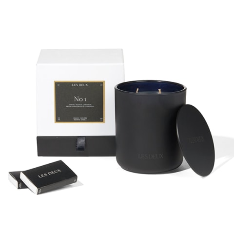 black candle with black cover and matchsticks