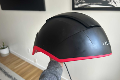 iRestore Elite hat in writer's hand