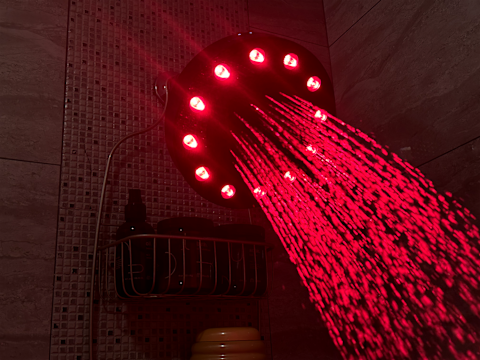 Higherdose red light showerhead filter with light on in testers' shower