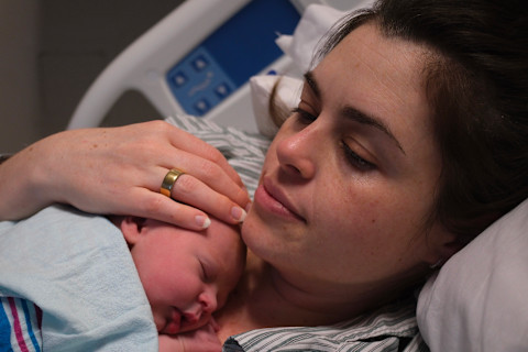 Mom with Oura ring on with newborn
