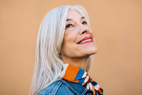 Portrait of a Woman in Her 60s Smiling and Looking Up Portrait of a Woman in Her 60s Smiling and Looking Up