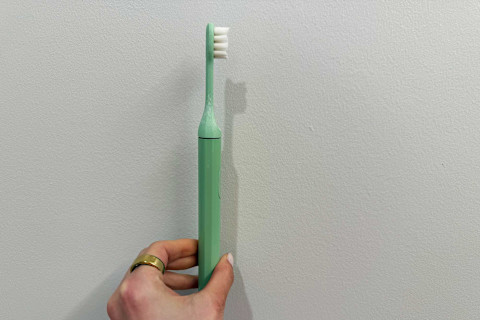 photo of SURI toothbrush in writer's hand