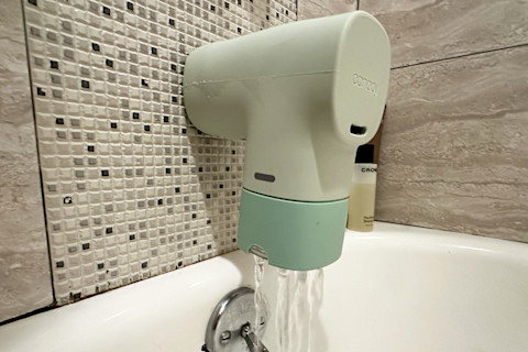 Canopy Bath Tub Filter installed on bath tub spout with water coming out