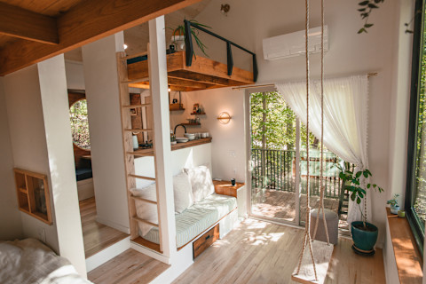 bright cabin living room with swing 