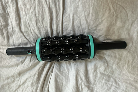 chirp rpm rolling percussive massager on gray bedding