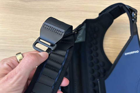 close-up image of hand holding adjustable strap on Omorpho G-Vest+