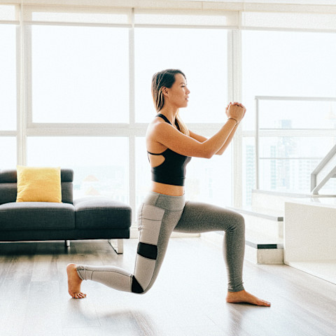 Woman Doing Lunges in Her Living Room Woman Doing Lunges in Her Living Room