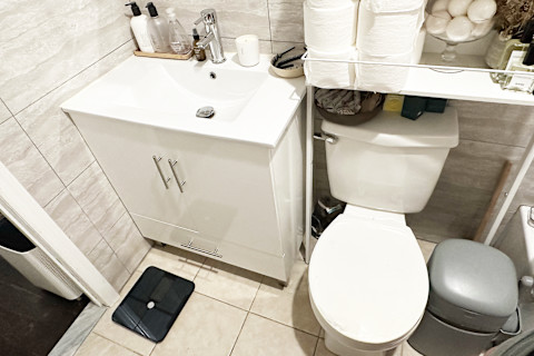 bathroom scale set up in corner of bathroom 