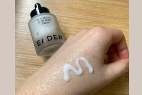 Eadem Milk Marvel Dark Spot Serum on Hand next to bottle
