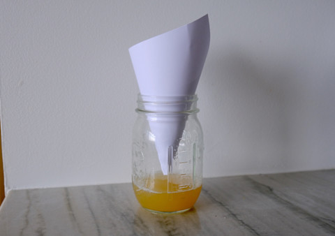 mason jar filled with apple cider vinegar and paper funnel mason jar filled with apple cider vinegar and paper funnel