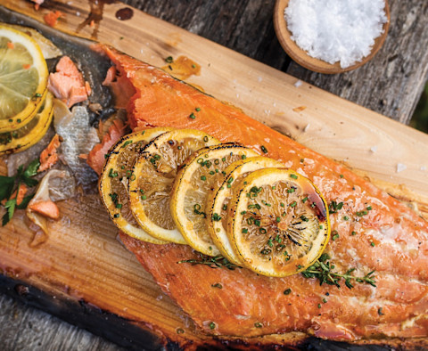 salmon on wood board with lemon on top salmon on wood board with lemon on top
