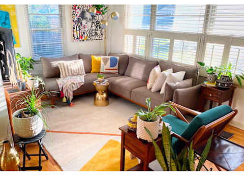 bright living room with sectional and coloful pillows