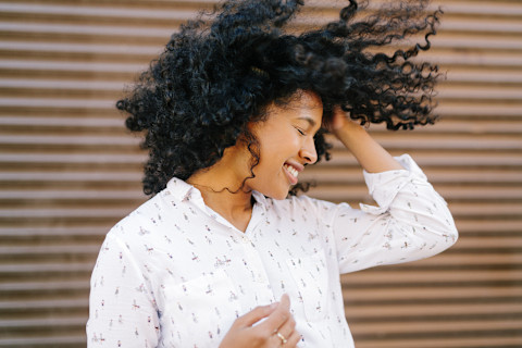 Woman Smiling with Hands in Hair Woman Smiling with Hands in Hair