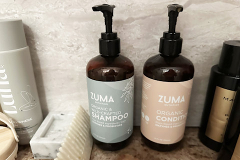 Zuma shampoo & conditioner bottle in shower on shelf