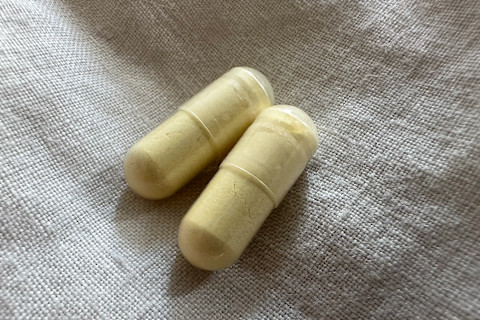 qualia nad+ two capsules on linen bedspread