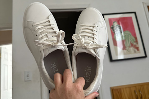 Kizik Sneaker held up in air by tester