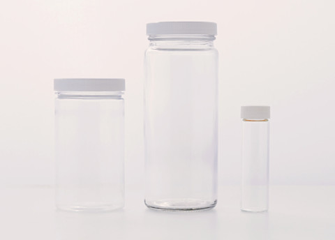three empty plastic containers of various sizes three empty plastic containers of various sizes
