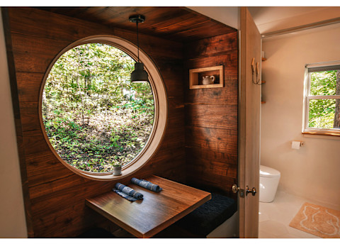 wood-panel room with large circular window