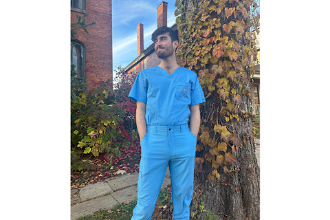 man standing in front of tree wearing blue scrubs man standing in front of tree wearing blue scrubs