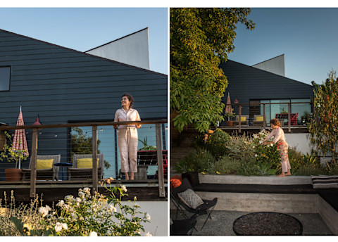woman in front of modern home watering the landscaping