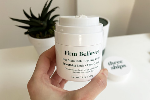 unboxed photo of three ships firm believer cream held in hand over desk