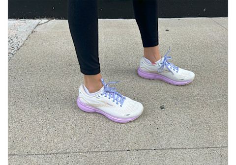 Brooks Ghost 15 Running Shoe on feet on sidewalk with leggings