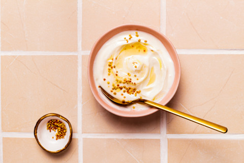 Bowl of Greek Yogurt topped with honey, bee pollen and honeycomb Bowl of Greek Yogurt topped with honey, bee pollen and honeycomb