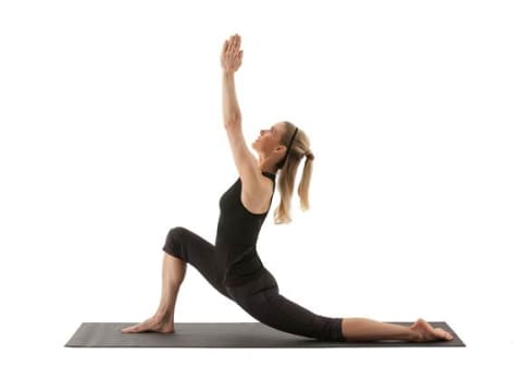 side view of woman demonstrating crescent lunge yoga pose side view of woman demonstrating crescent lunge yoga pose