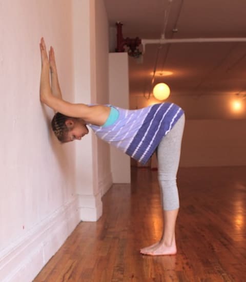 shoulder opener at wall yoga pose
