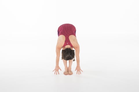 woman demonstrating standing forward fold yoga