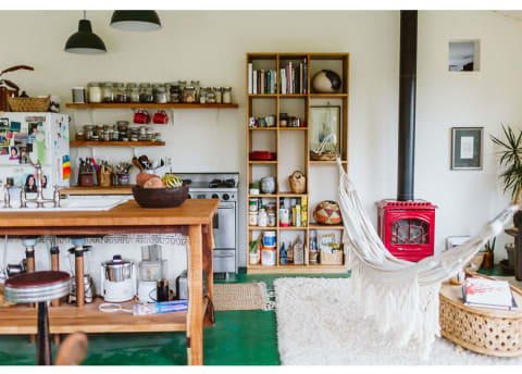 fun living area and kitchen with green floor and hammock