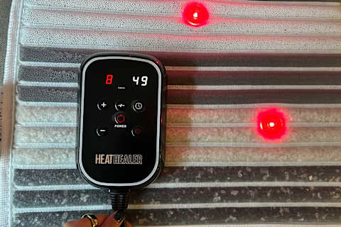 close up photo of heat healer mat with remote control