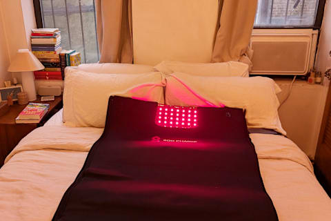 Bon Charge Red Light Blanket on bed with lights on