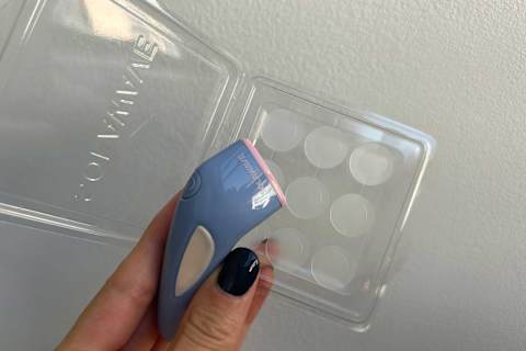 photo of the bye acne device in the writer's hand with the microdart patches