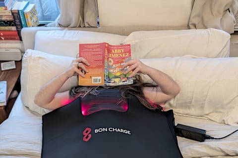 Bon Charge red light blanket in bed with user reading