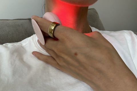 hand holding solawave mini on neck