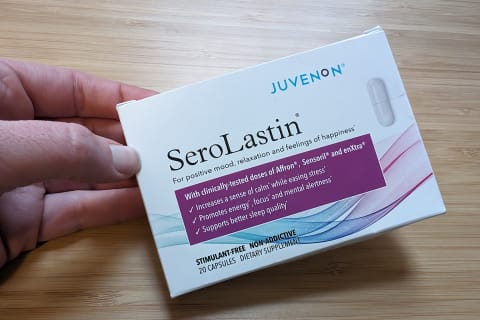 Juvenon Serolastin box held in hand on right side of screen