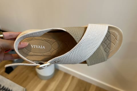 photo of editor's hand holding up the vivaia adaptall sport sandal