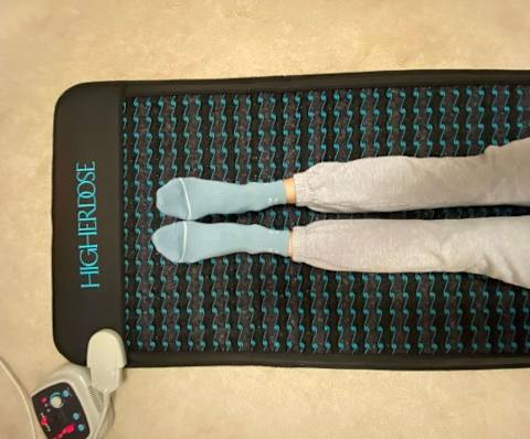 photo of editor's legs on higherdose pemf mat on carpet