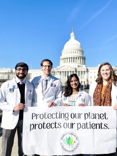 med students with protecting our planets protecting our patients sign in washington dc
