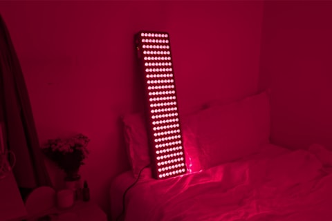 Bon Charge Max Red Light Therapy Panel on bedroom making room glow red