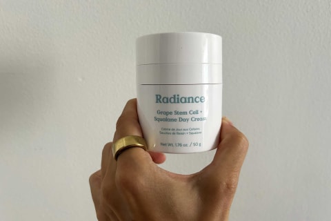 editor's hand holding radiance cream