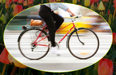 person biking through busy street