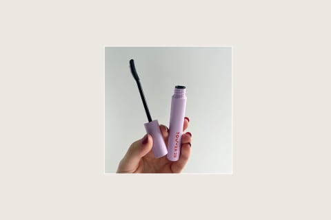 Tower28 mascara held in hand with wand out of tube