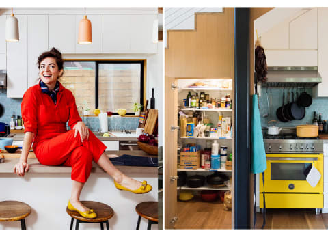 woman in red jumpsuit sitting in her colorful kitchen