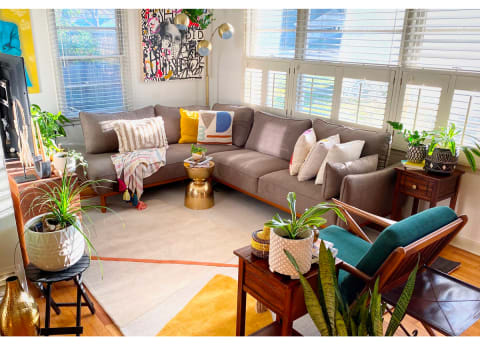 bright living room with sectional and coloful pillows