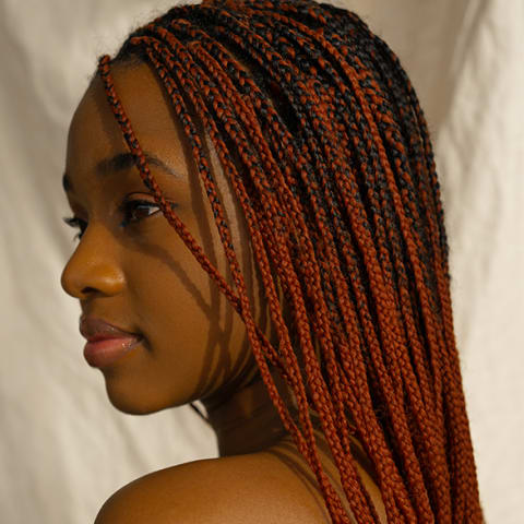 woman with red box braids