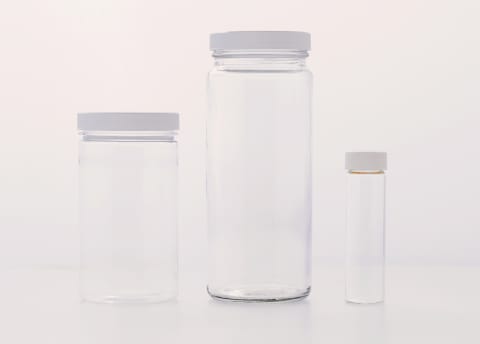 three empty plastic containers of various sizes