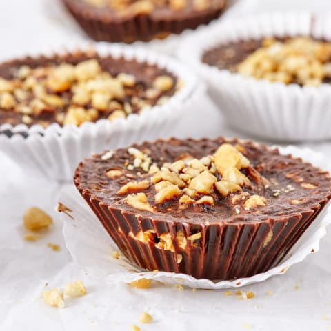 A simple recipe of coconut oil, carob powder, peanut butter, and peanuts makes these delicious and healthy chocolate alternative confection.