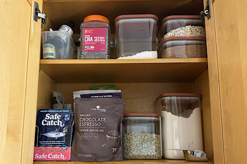 Caraway Airtight Glass Container set in cupboard filled with seeds, flour, and sugar